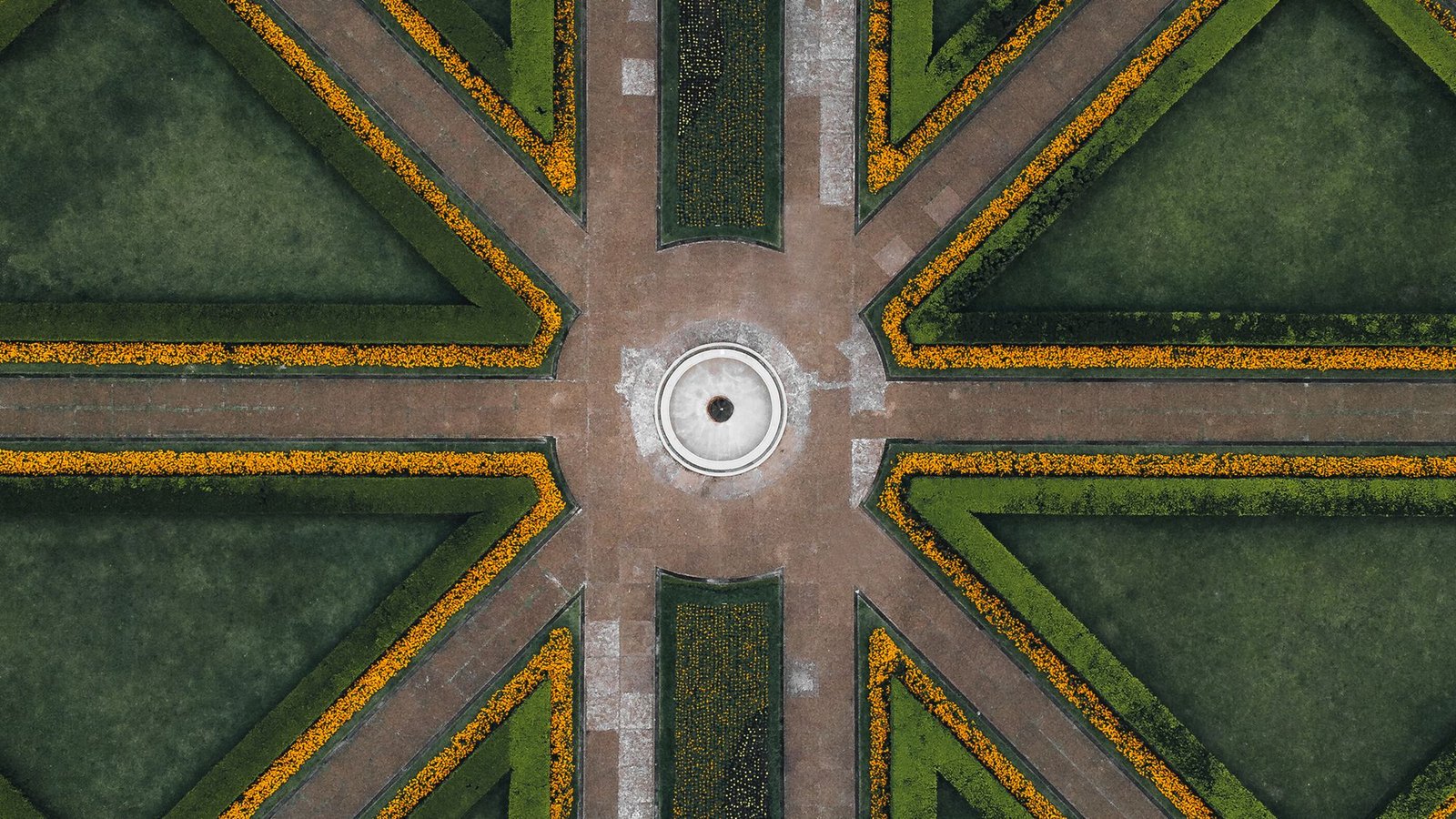 Aerial view of a formal landscape of hedged compartments and gravel paths