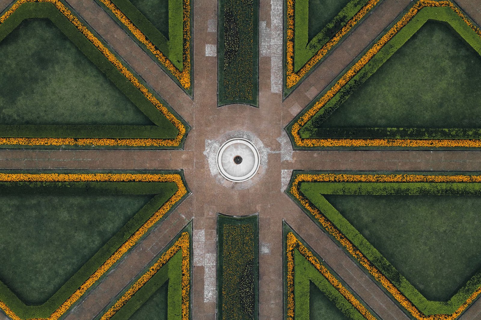 Aerial view of a formal landscape of hedged compartments and gravel paths