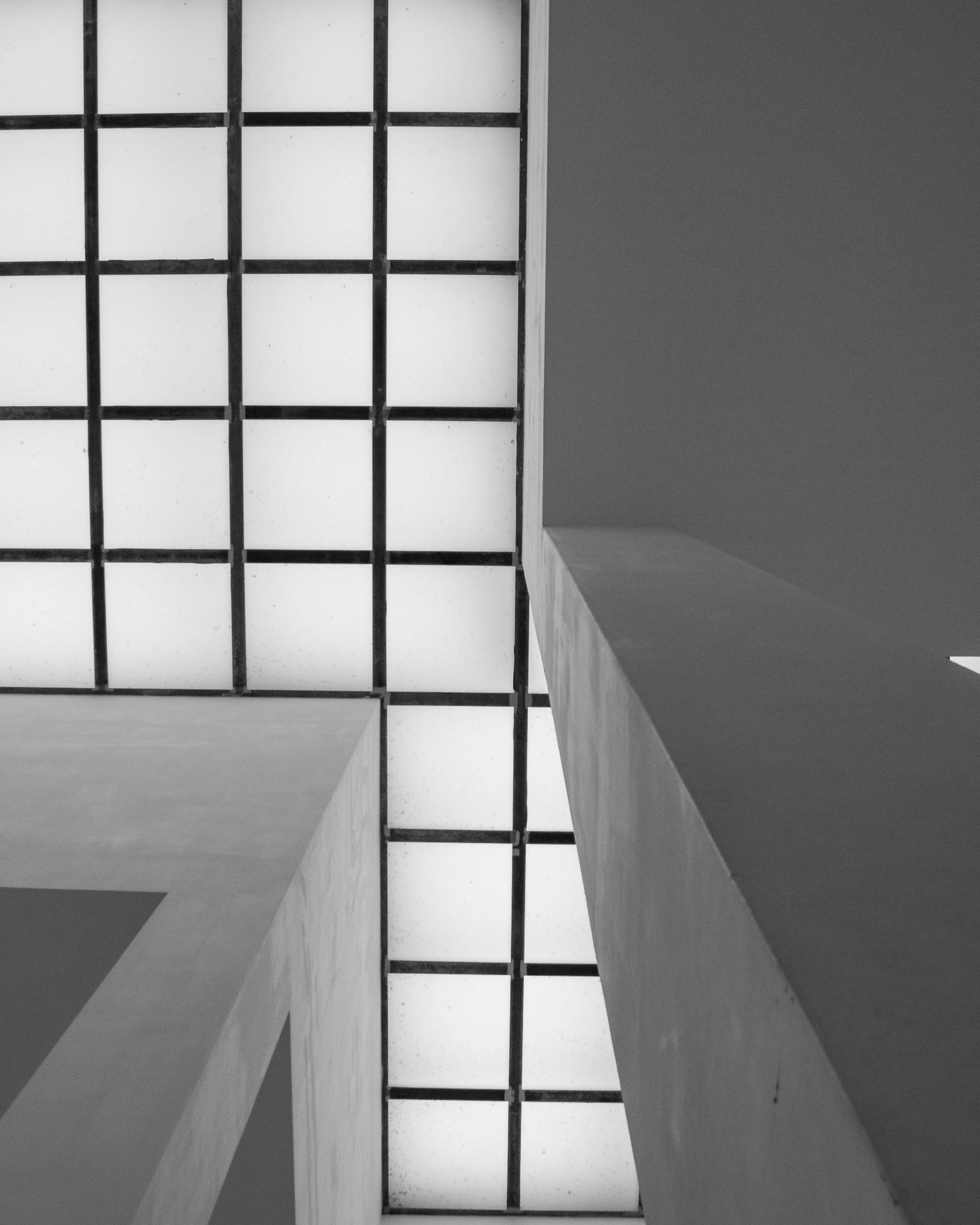 Grid of glass blocks lighting a pale concrete stair