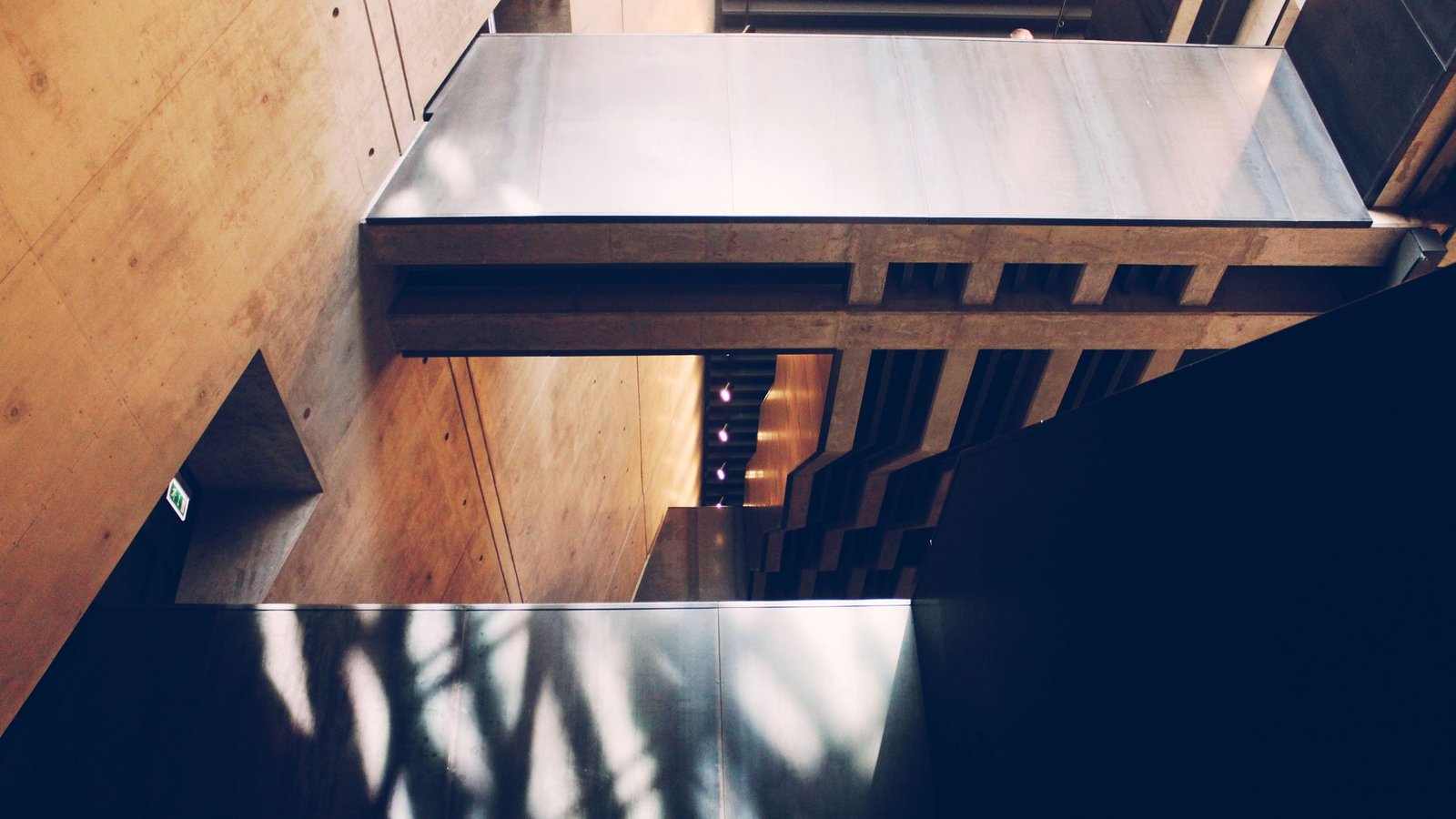 Timber interior with the shadow of leaves falling across the floor