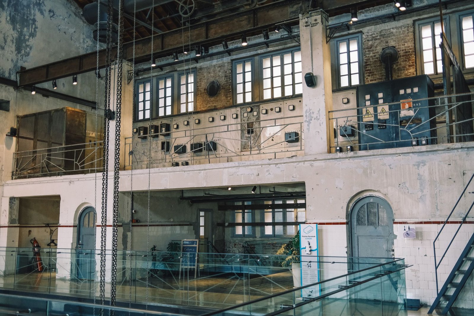 Converted industrial interior with original machinery and pipework retained