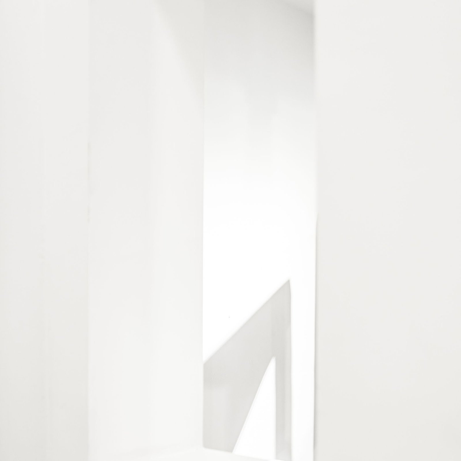 White light shaft with a hard diagonal shadow falling across it