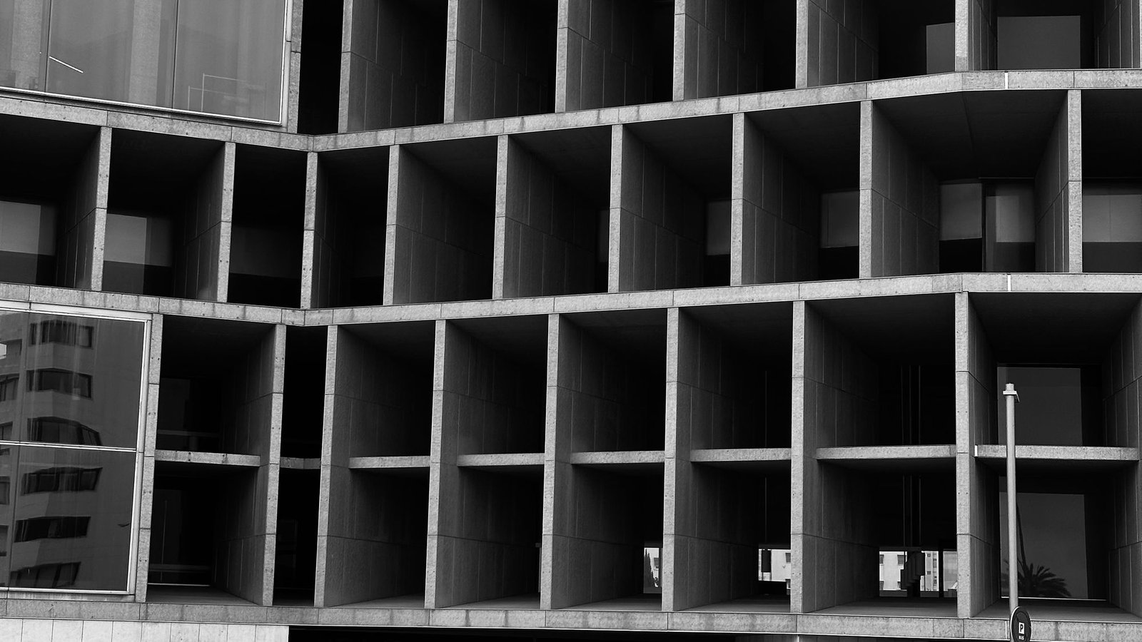 Finished deep concrete grid facade photographed in black and white