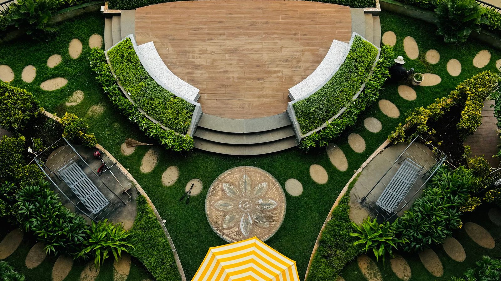 Circular planted garden seen from above with a curved retaining wall