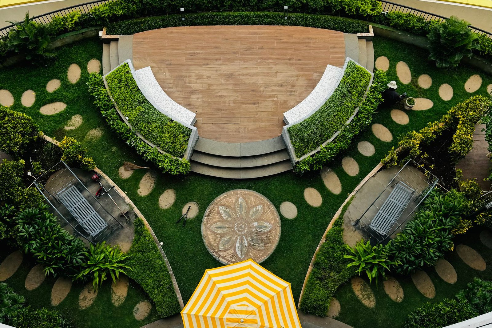 Circular planted garden seen from above with a curved retaining wall
