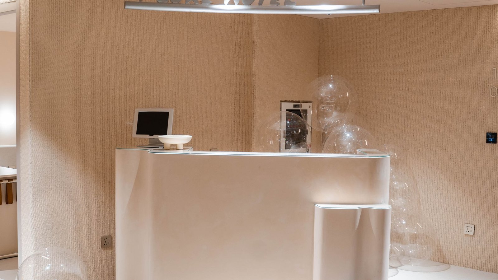 Minimal white reception space with a curved plaster counter