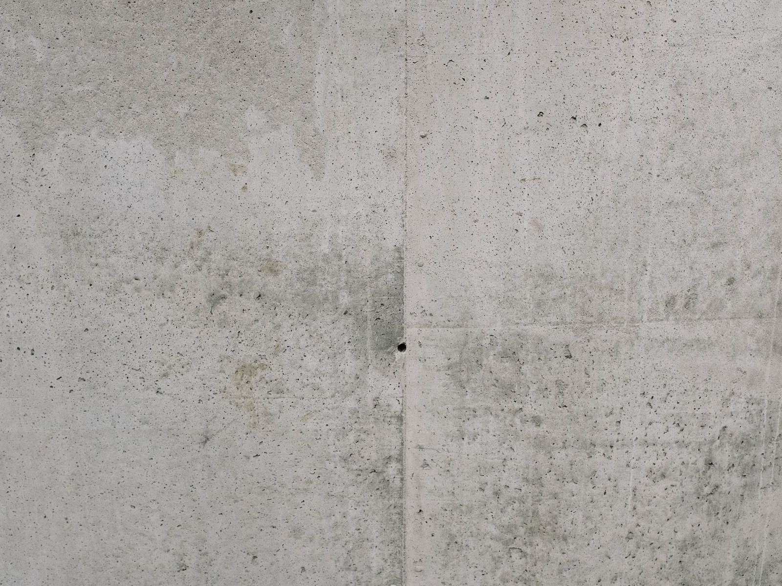 Board-marked concrete surface with visible timber grain and tie holes