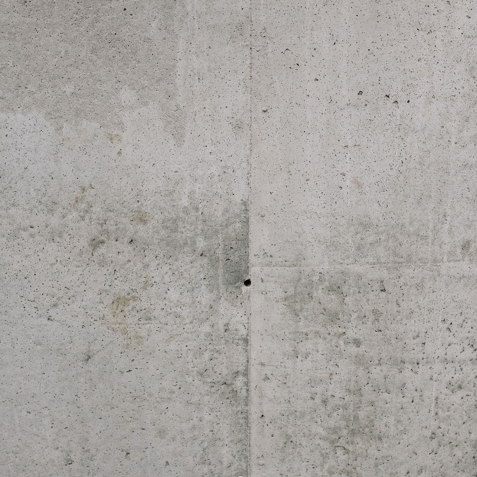 Board-marked concrete surface with visible timber grain and tie holes