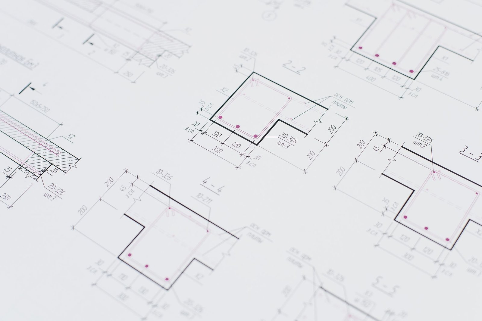 Technical floor plan drawings laid out flat on a desk