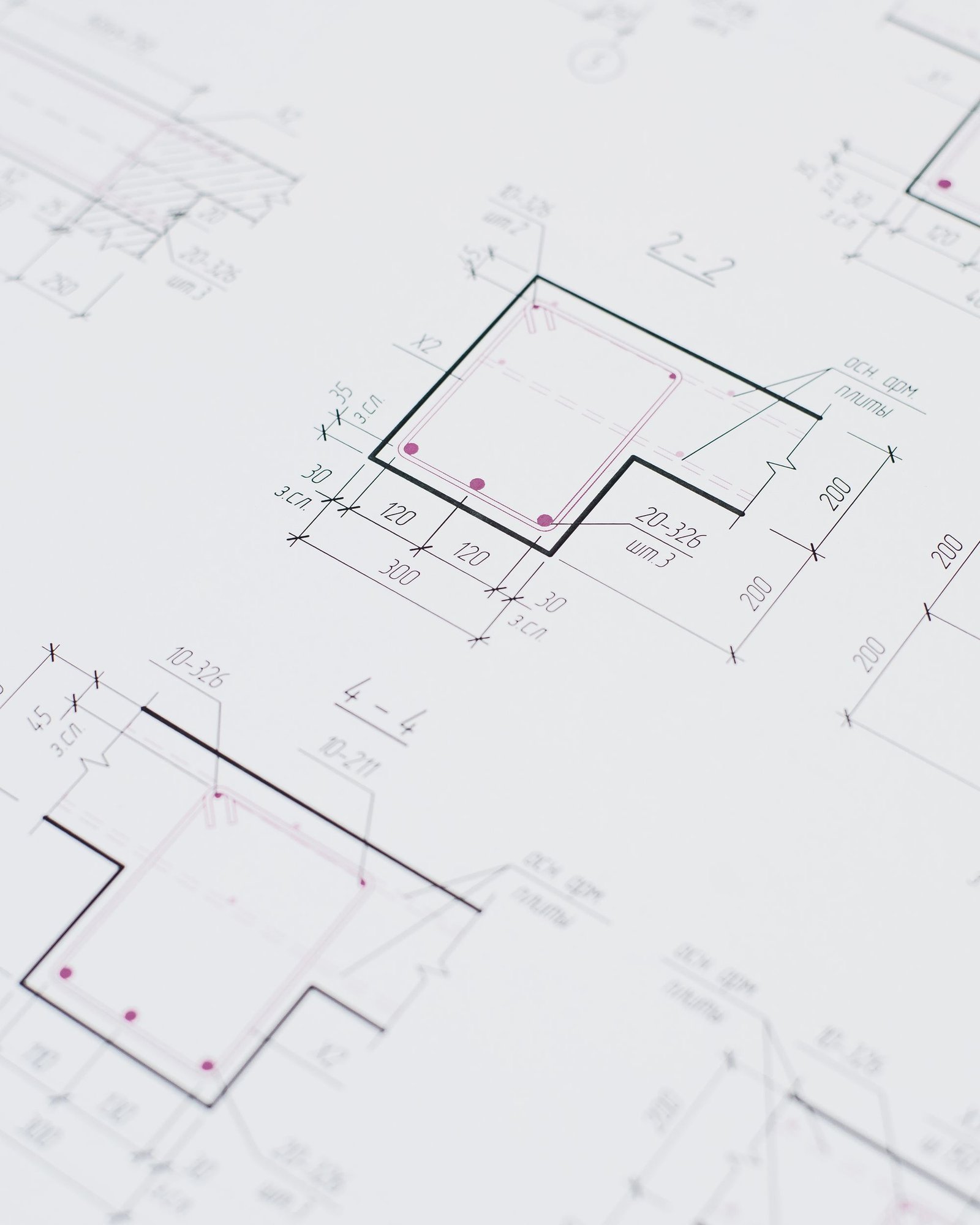Technical floor plan drawings laid out flat on a desk