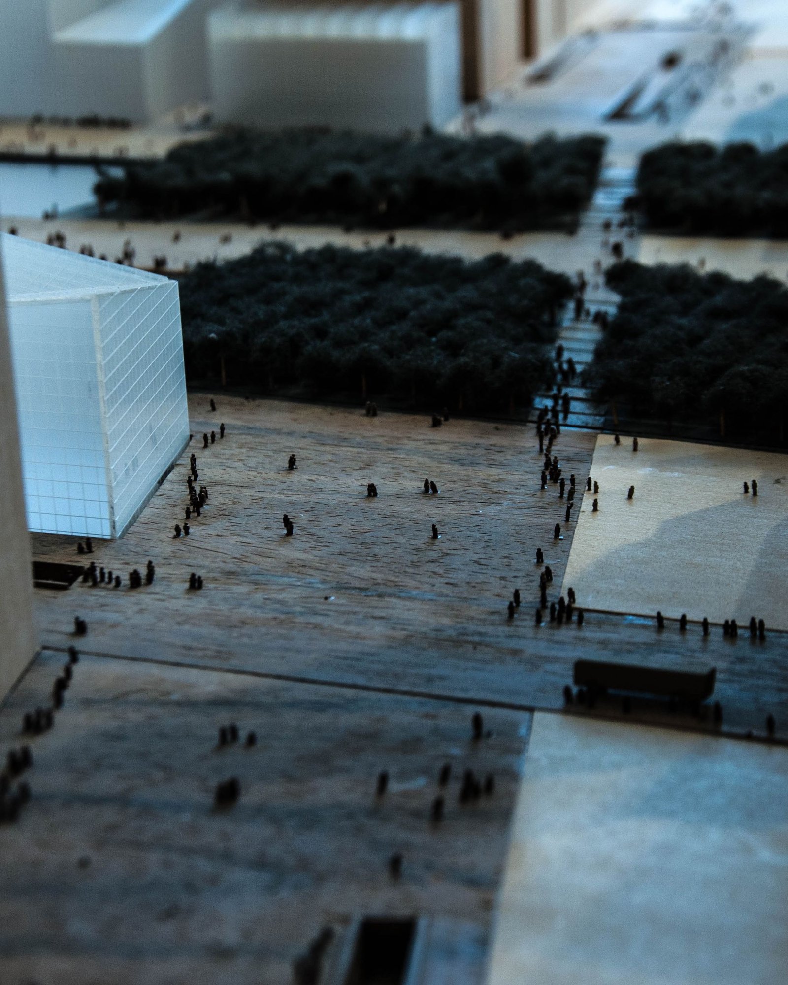 Detailed grey massing model of an urban district on a studio table
