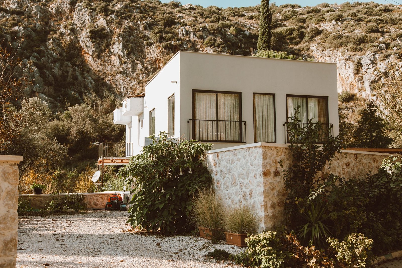 Whitewashed building set into a rocky hillside