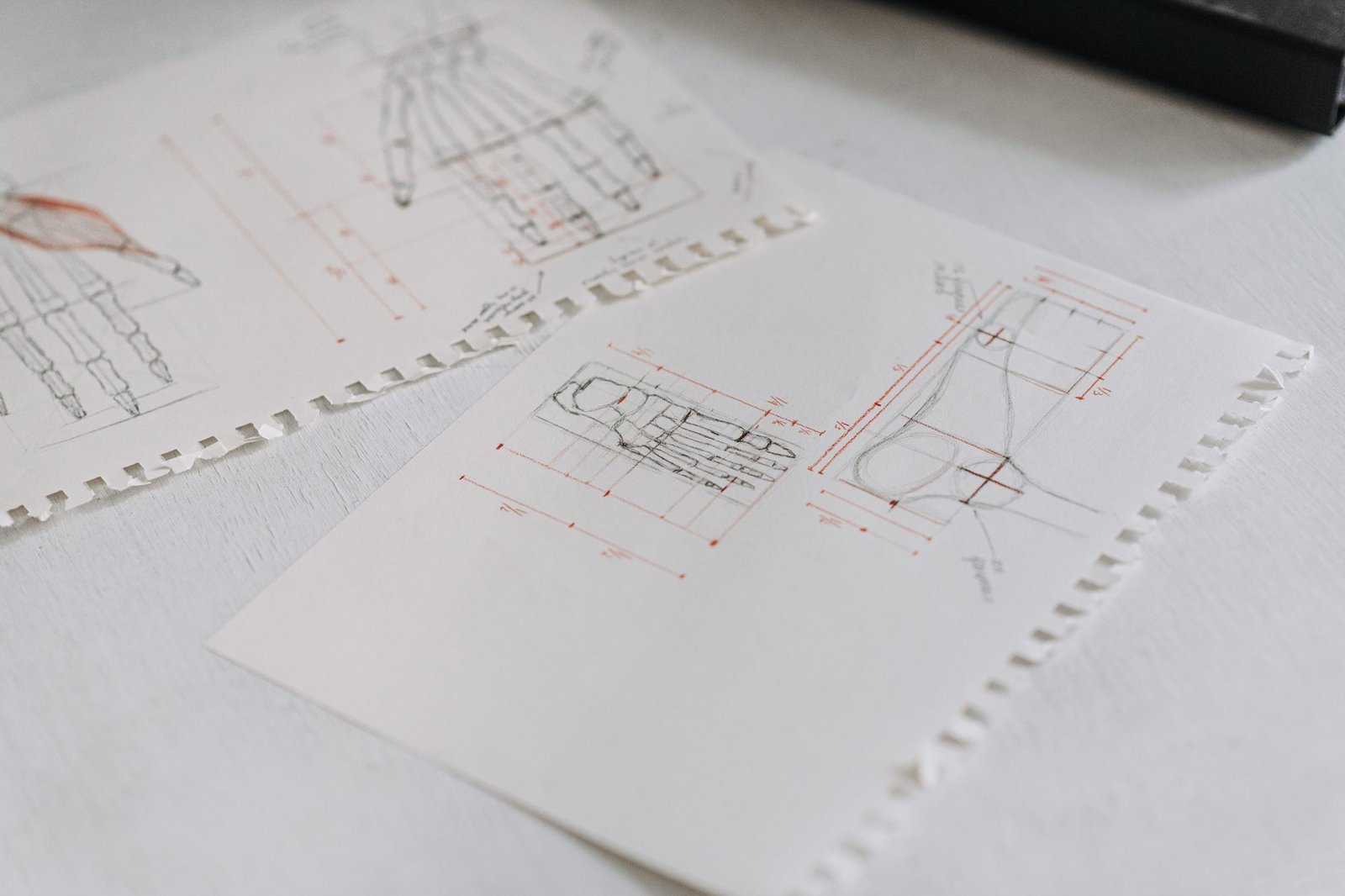 Soft-focus technical drawings laid out in neat overlapping sheets