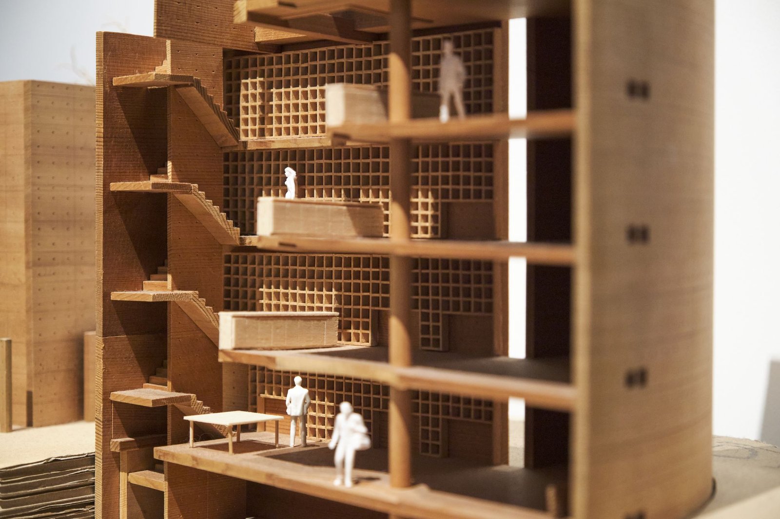 Sectional timber model of a multi-storey building with tiny scale figures