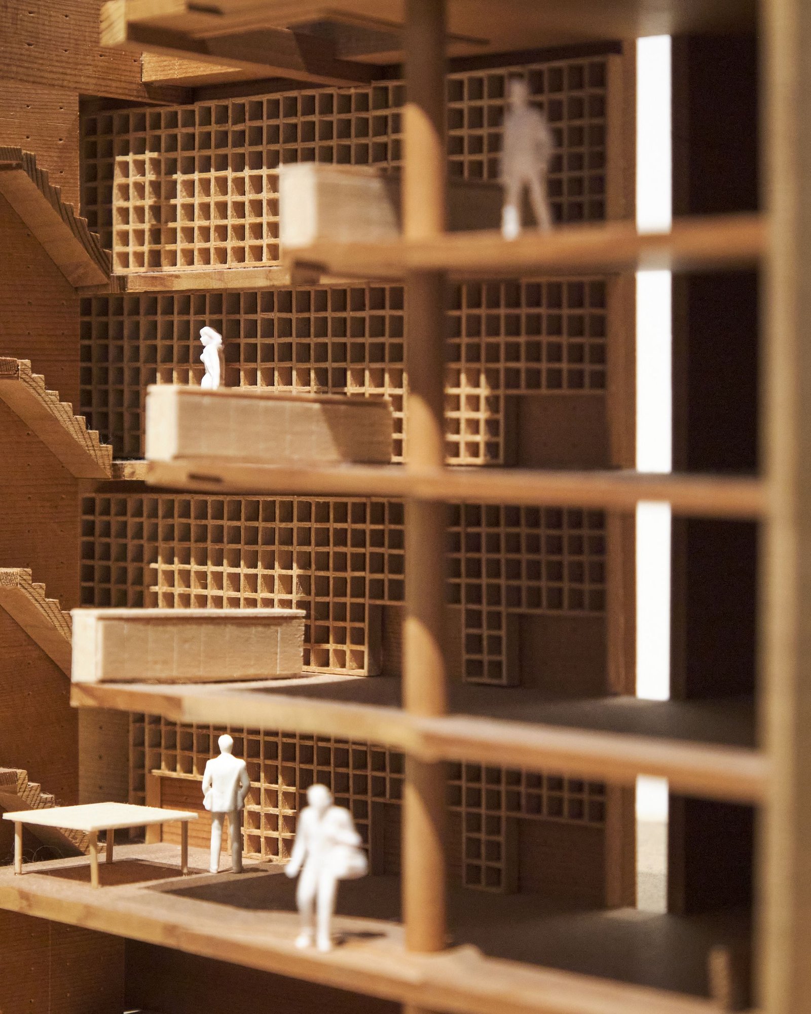Sectional timber model of a multi-storey building with tiny scale figures