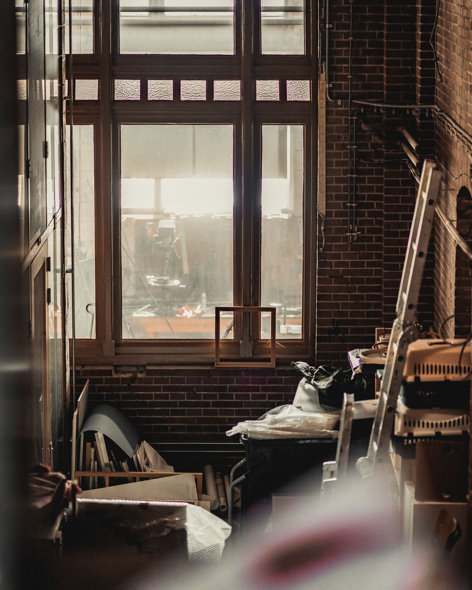 Industrial room with a large multi-pane window and worn timber floor
