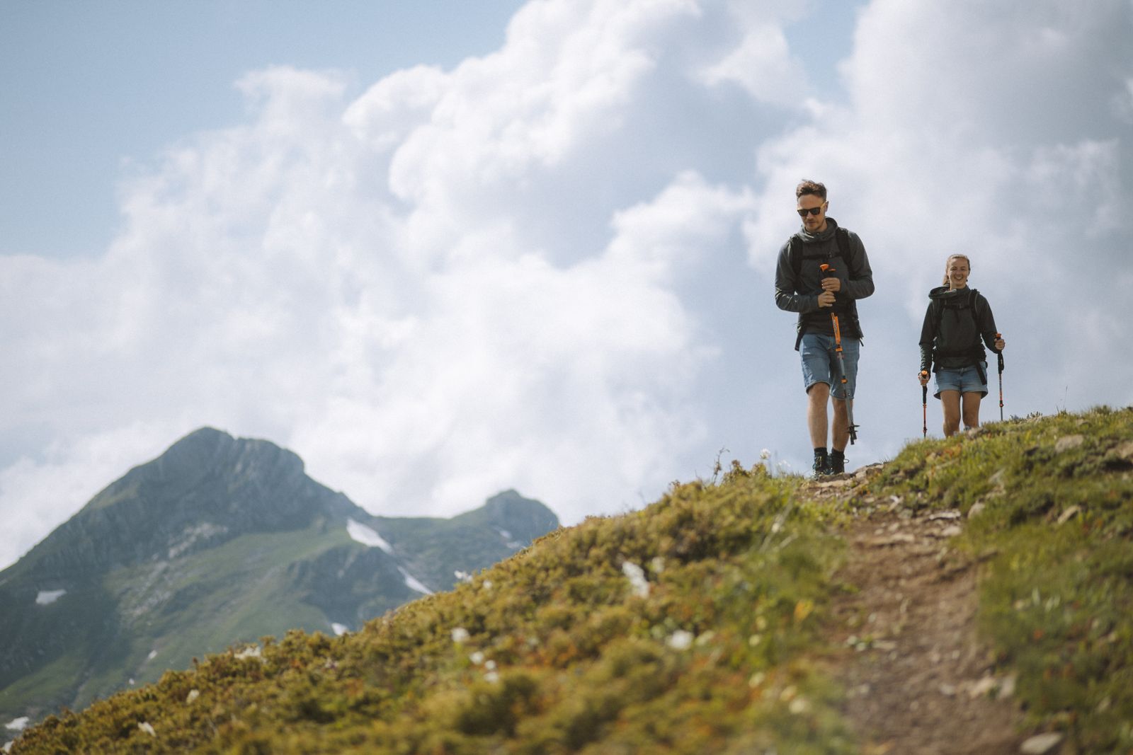 A couple hiking a ridgeline trail through the highlands