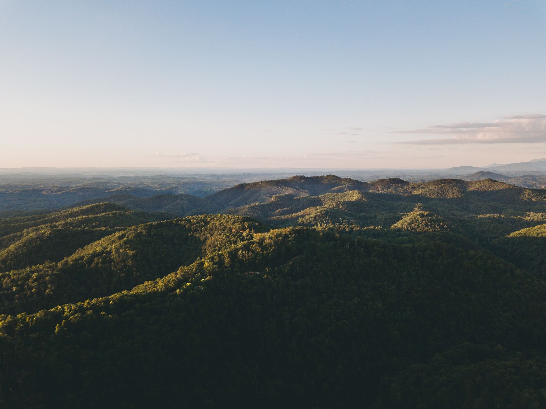 Layered green mountain ranges receding to the horizon