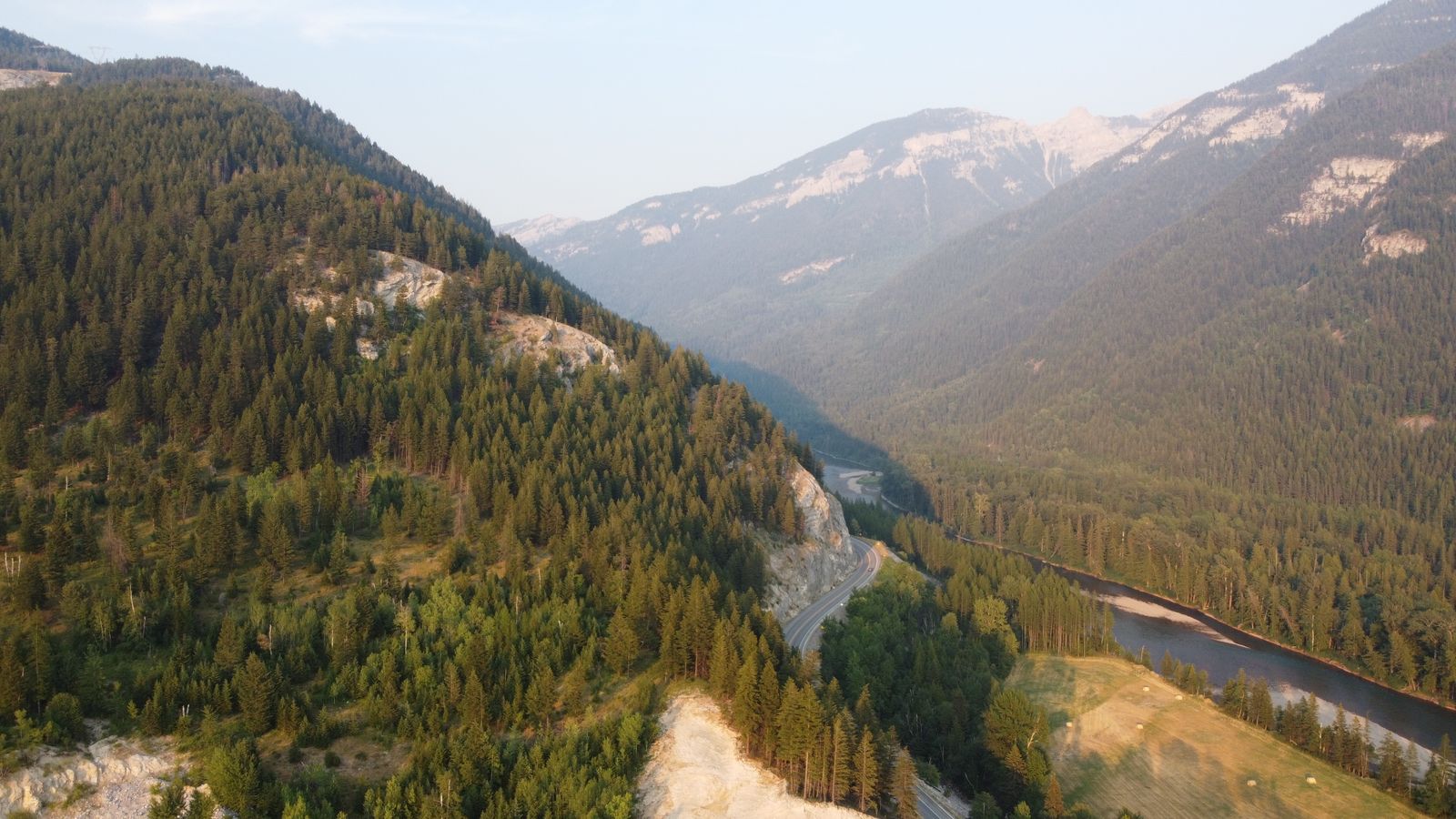 Aerial view of green mountains and a winding river