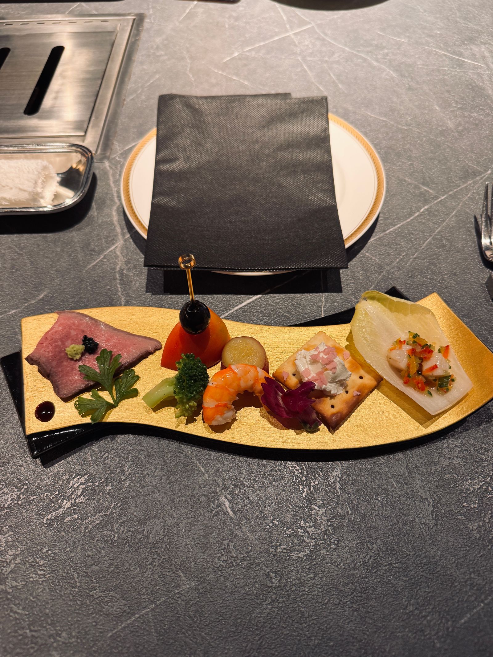 A plated gourmet appetiser of seasonal delicacies