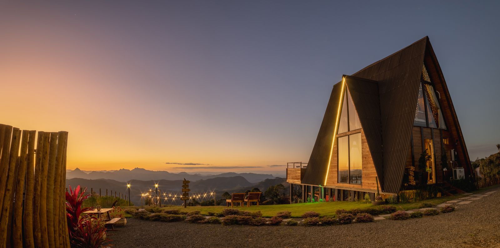 A luxurious A-frame residence glowing at dusk